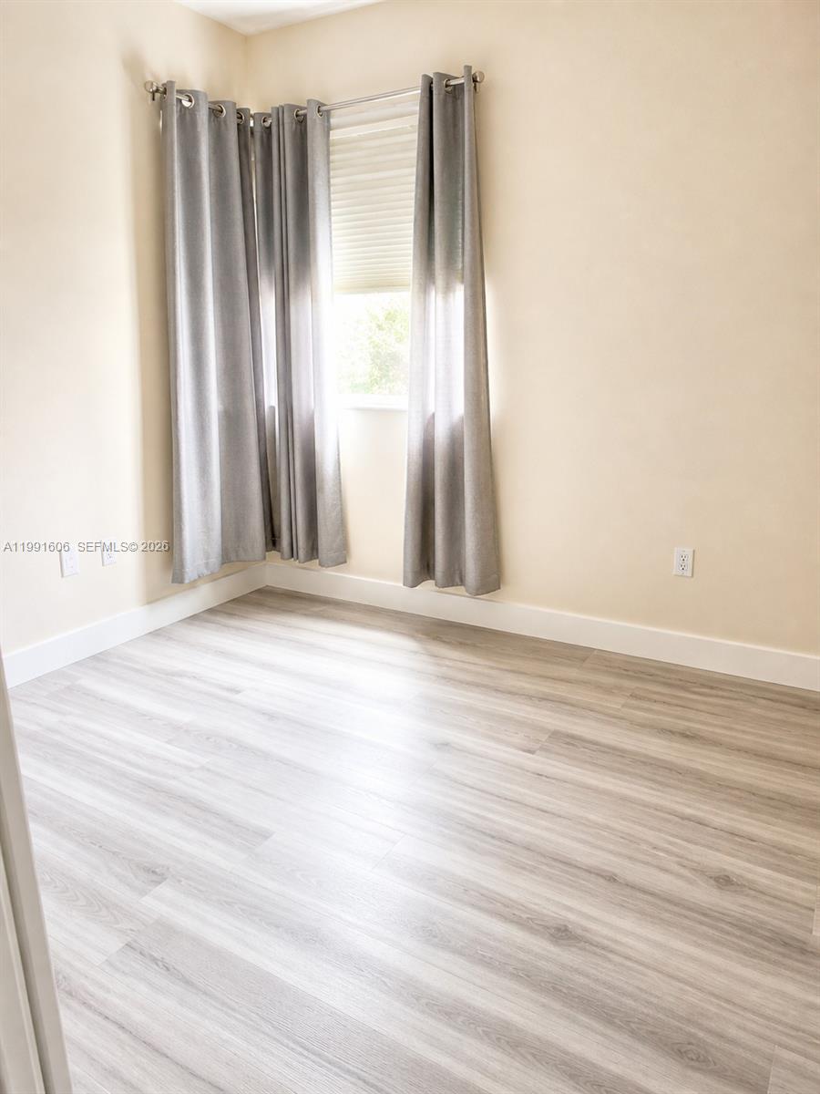 15615 Southwest 42nd Terrace Miami, FL 33185 - Photo 25 of 28 a view of wooden floor and windows in a room