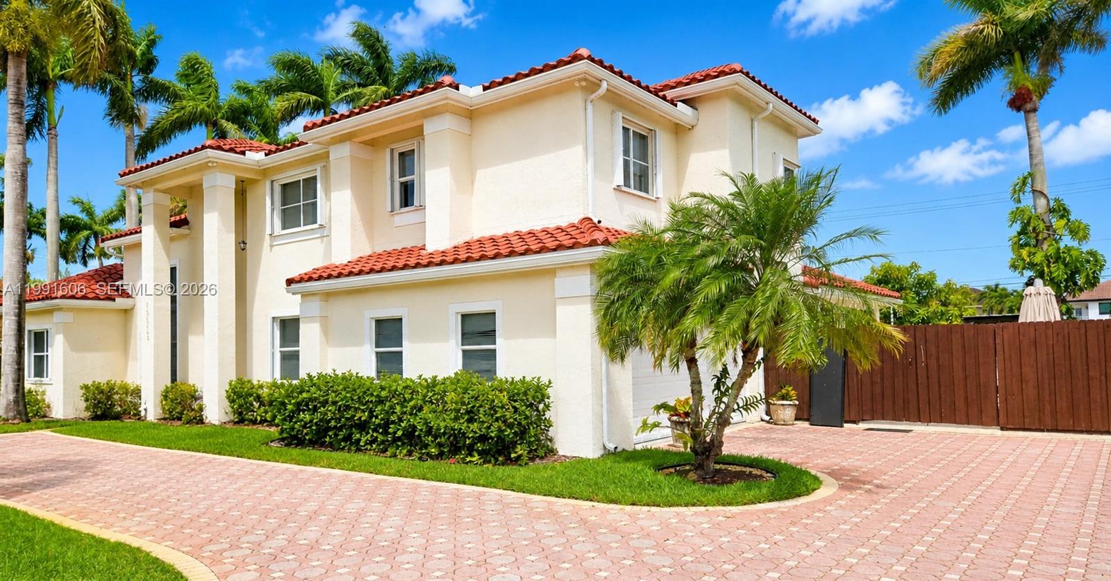 15615 Southwest 42nd Terrace Miami, FL 33185 - Photo 3 of 28 a front view of a house with a yard and a garage