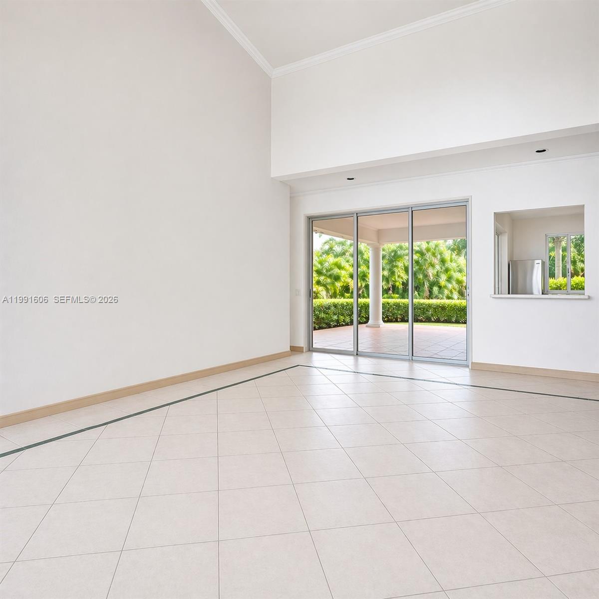 15615 Southwest 42nd Terrace Miami, FL 33185 - Photo 7 of 28 an empty room with floor to ceiling window and an outdoor view