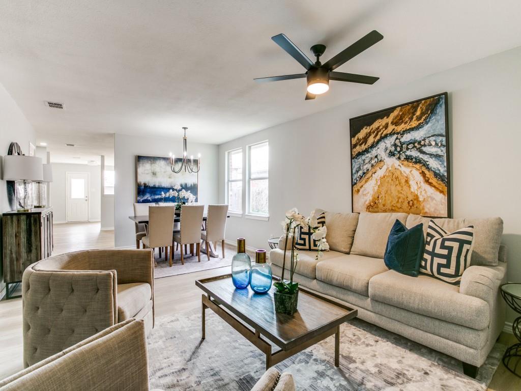 a living room with furniture and a view of kitchen