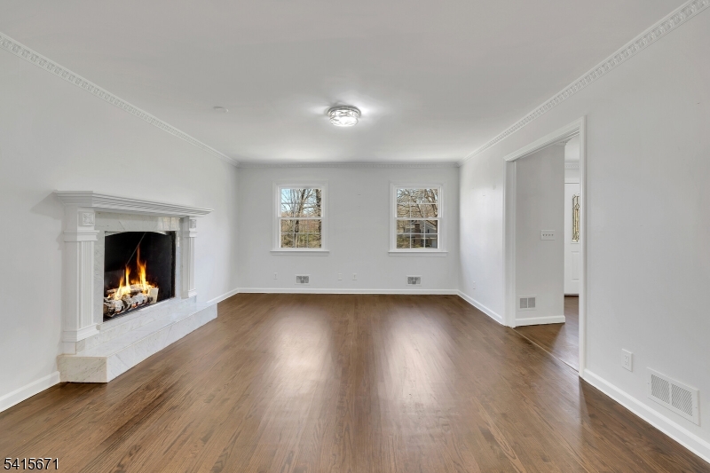 54 Robin Glen Road Watchung, NJ 07069 - Photo 23 of 42 an empty room with wooden floor fireplace and windows