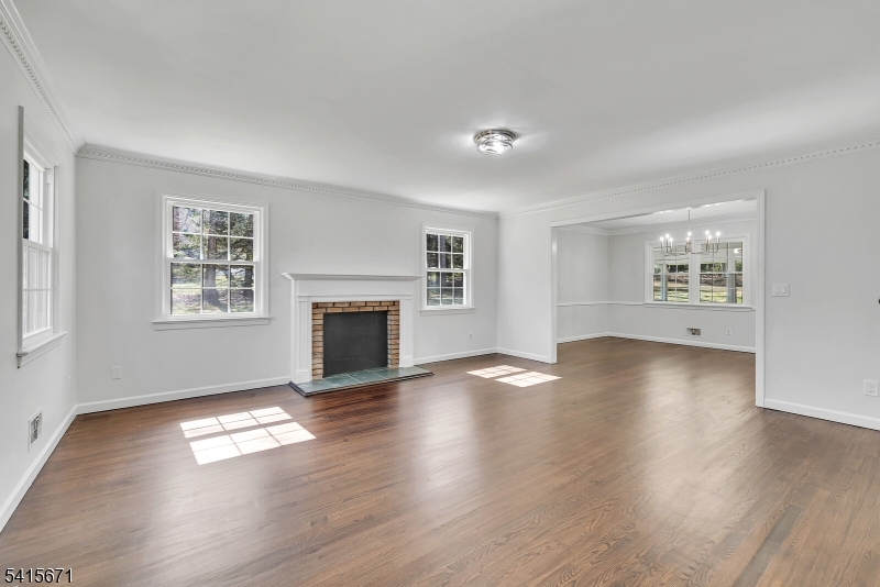 54 Robin Glen Road Watchung, NJ 07069 - Photo 4 of 42 a view of empty room with a fireplace and wooden floor