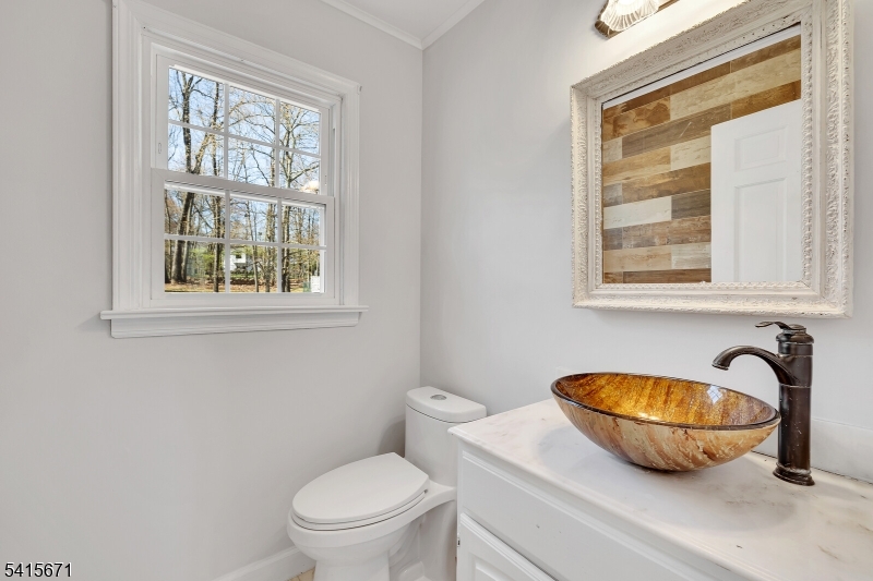 54 Robin Glen Road Watchung, NJ 07069 - Photo 8 of 42 a bathroom with a granite countertop toilet a sink and a window