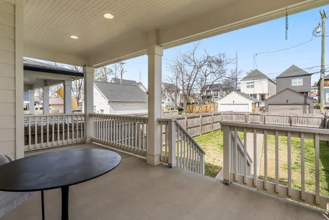 a view of a porch with furniture and floor to ceiling window
