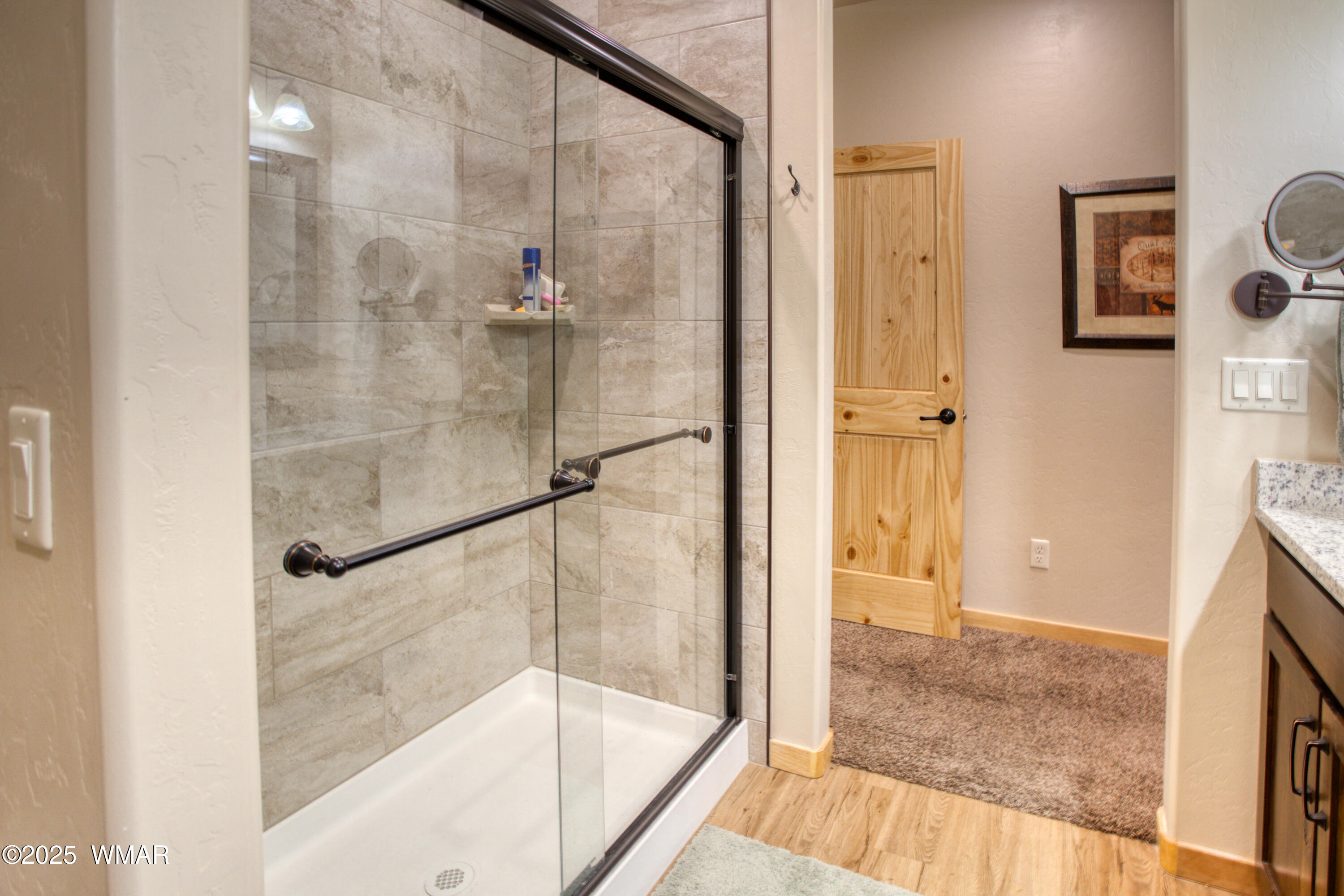 5863 Apollo Way Lakeside, AZ 85929 - Photo 10 of 16 a bathroom with a glass shower door