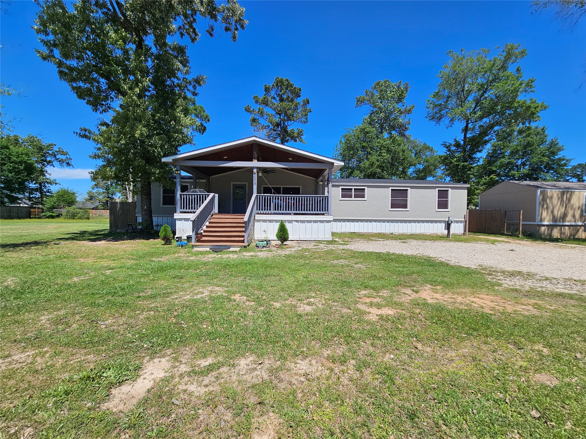 16313 Sandy View Drive Conroe, TX 77303 - Photo 1 of 41 a front view of a house with garden