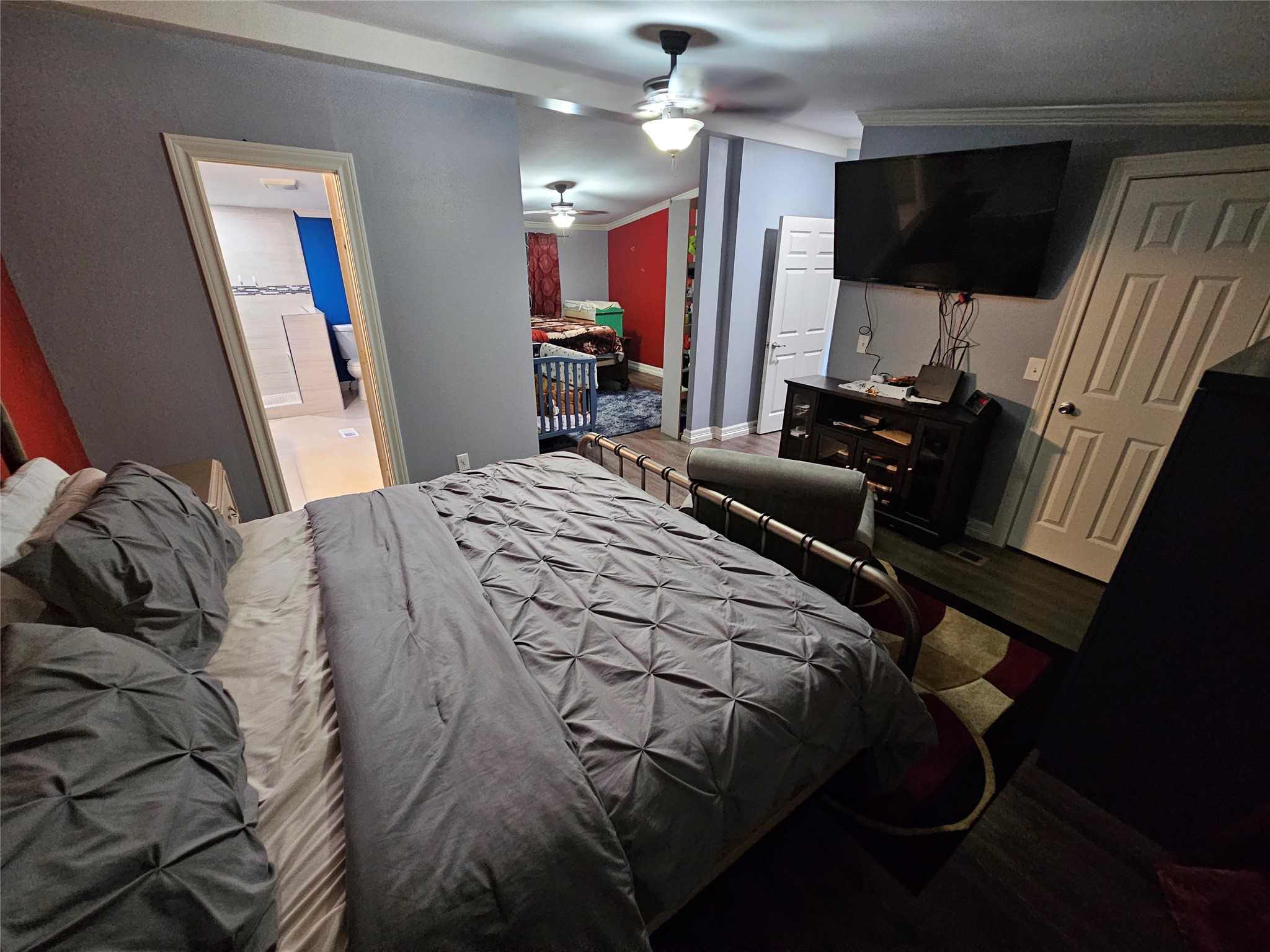 16313 Sandy View Drive Conroe, TX 77303 - Photo 13 of 41 a bedroom with a bed and a flat screen tv