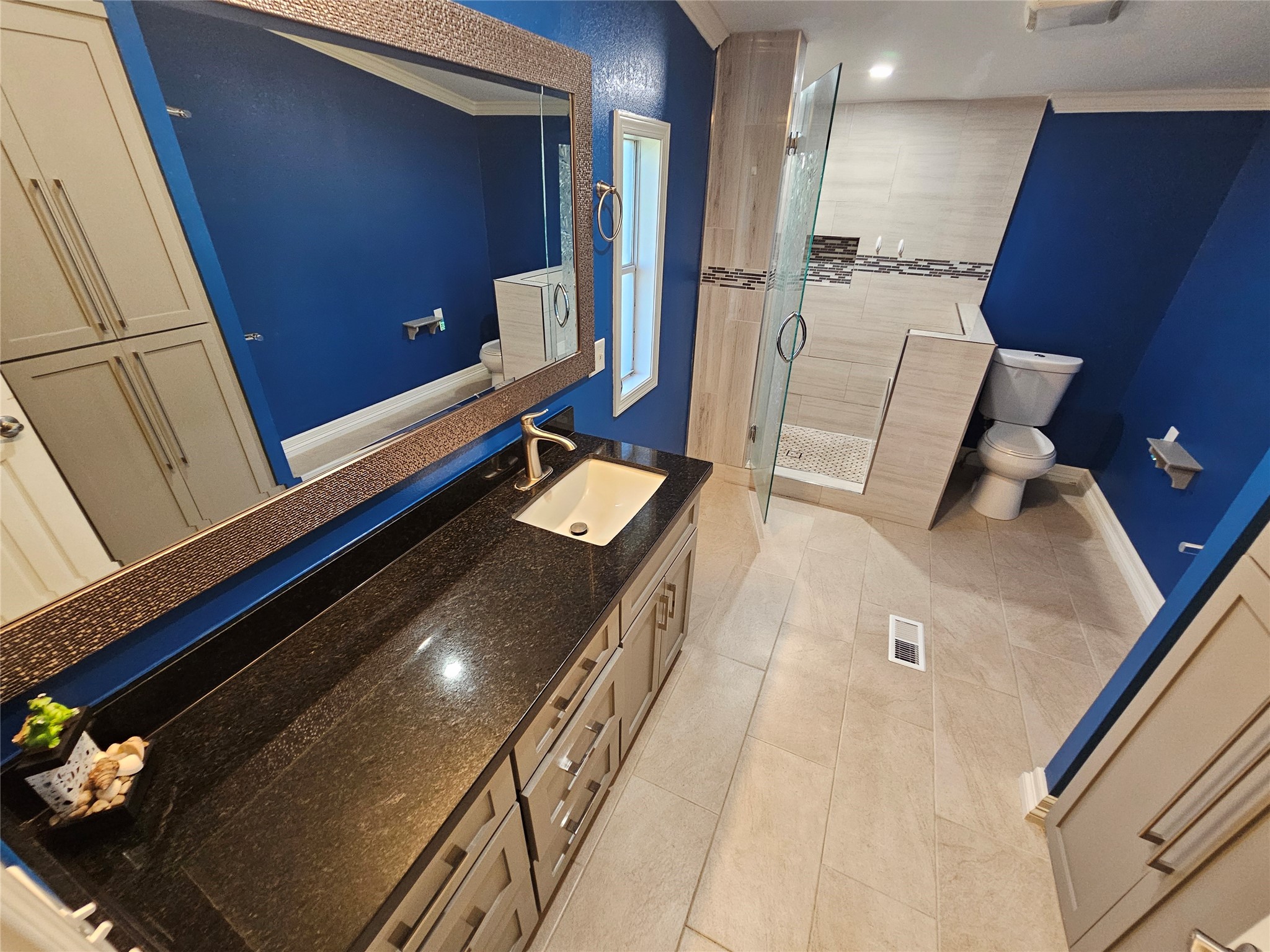 16313 Sandy View Drive Conroe, TX 77303 - Photo 16 of 41 a bathroom with a double vanity sink and mirror