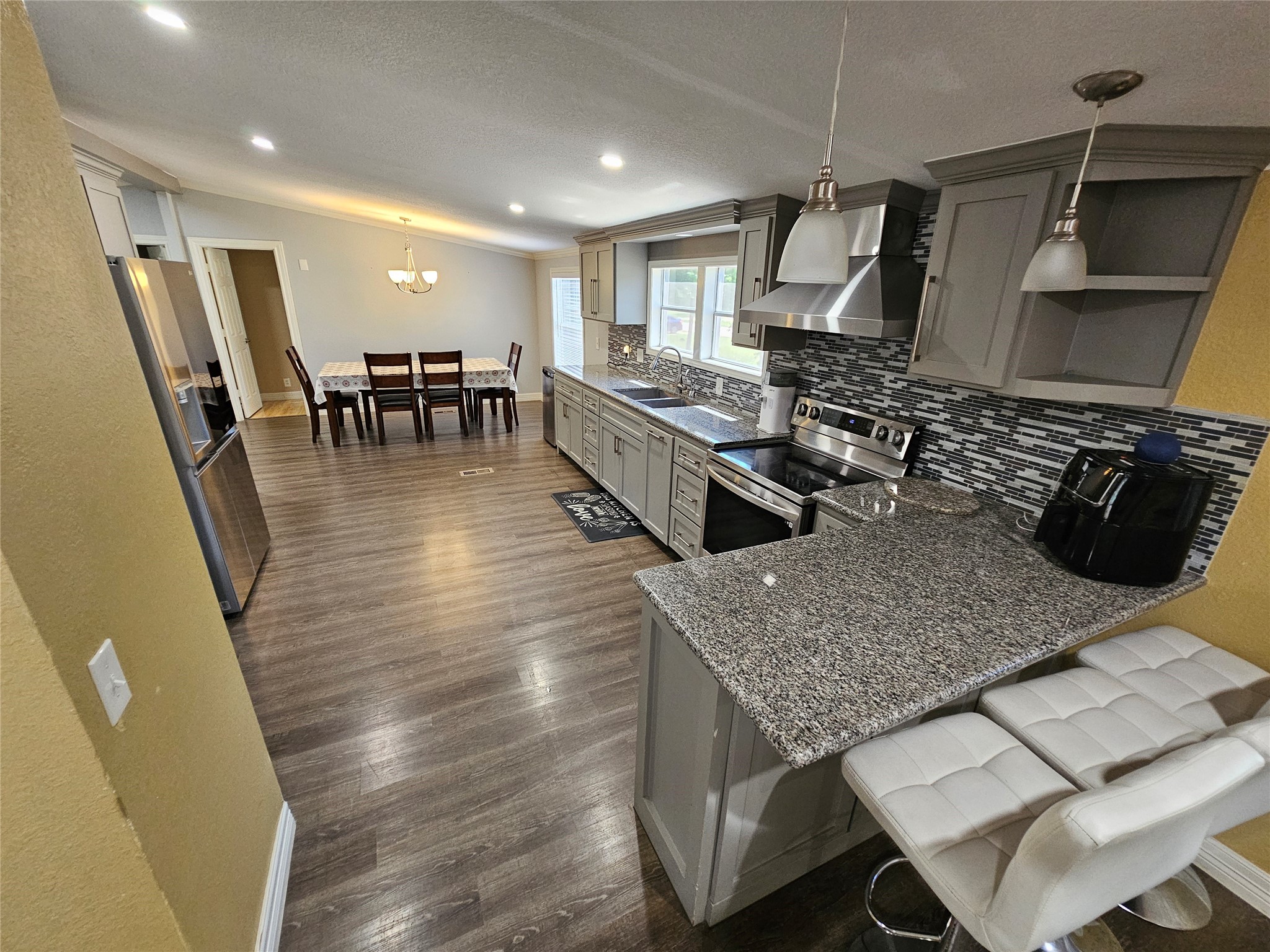 16313 Sandy View Drive Conroe, TX 77303 - Photo 19 of 41 a kitchen with a table chairs and a wooden floor