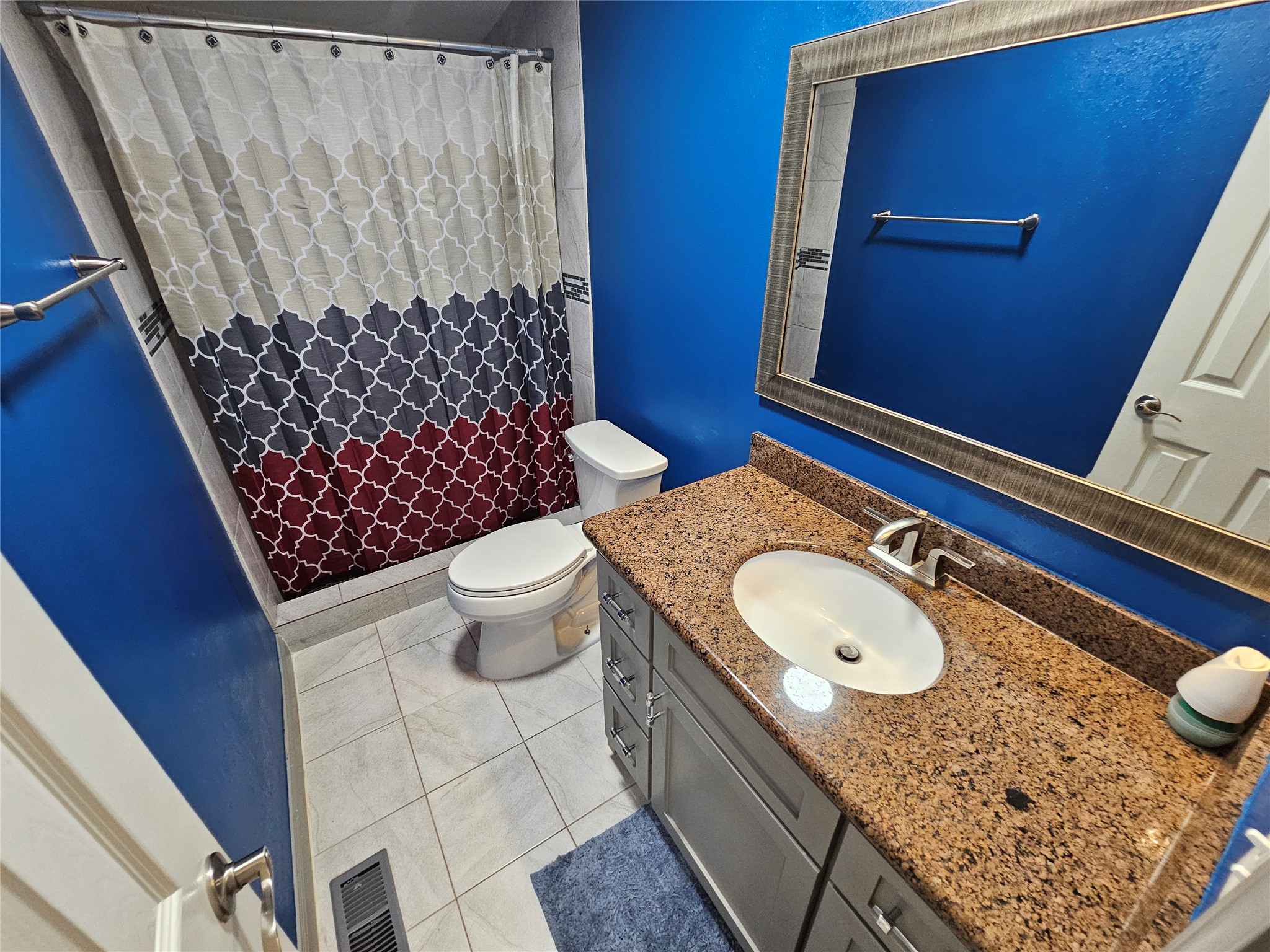 16313 Sandy View Drive Conroe, TX 77303 - Photo 29 of 41 a bathroom with a granite countertop toilet sink and mirror