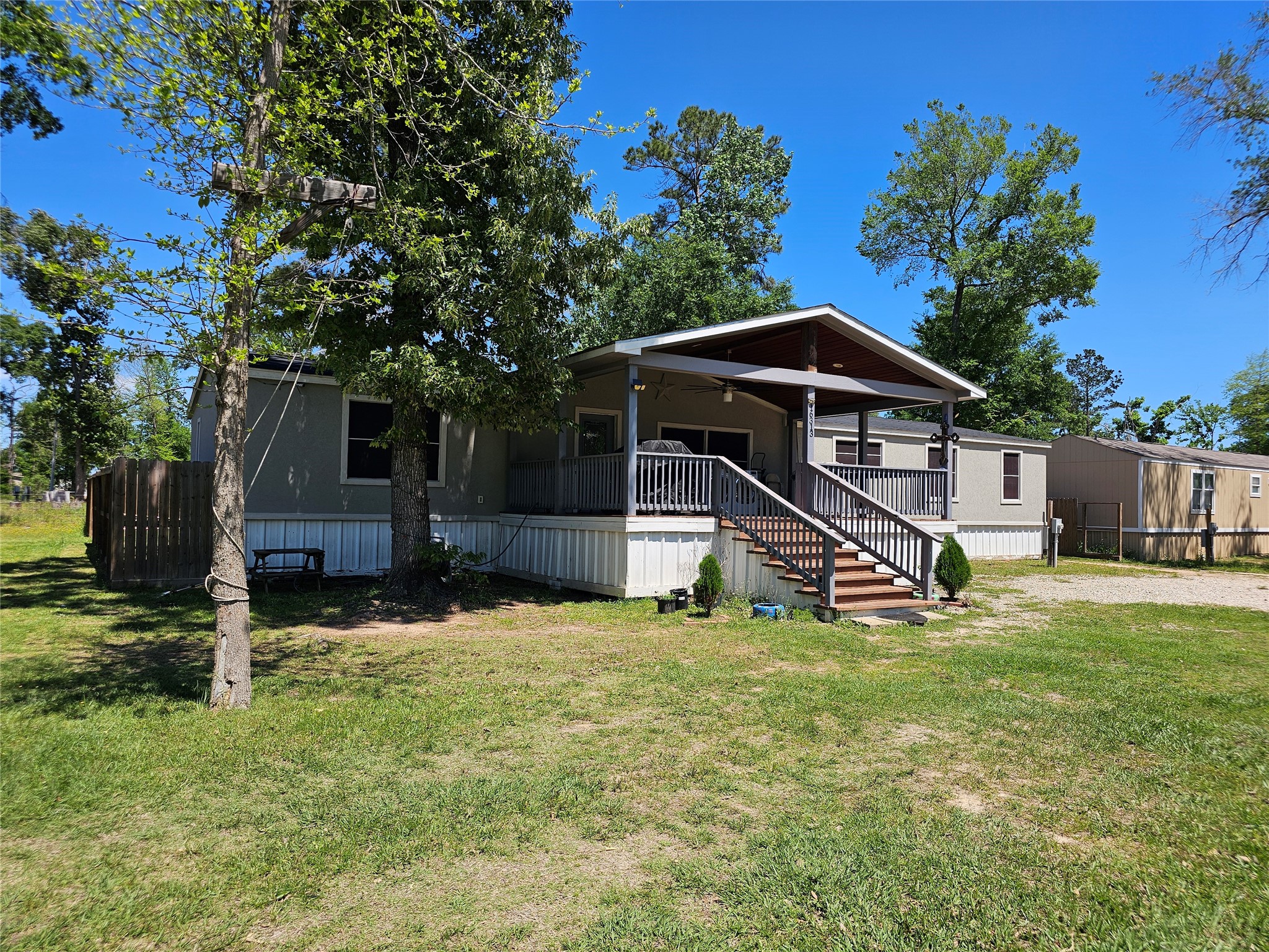 16313 Sandy View Drive Conroe, TX 77303 - Photo 3 of 41 a view of a house with backyard and trees