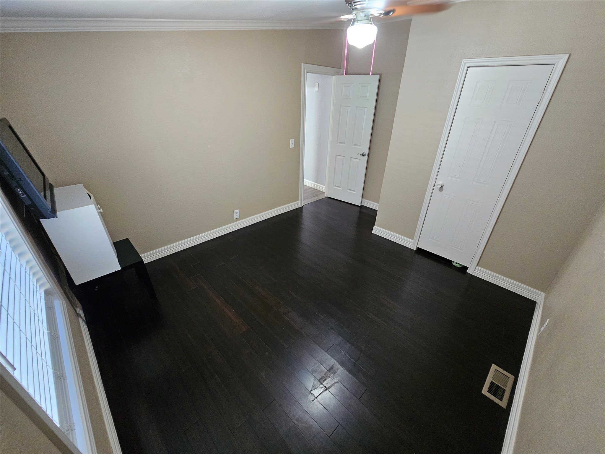 16313 Sandy View Drive Conroe, TX 77303 - Photo 32 of 41 a view of an empty room with wooden floor and a window