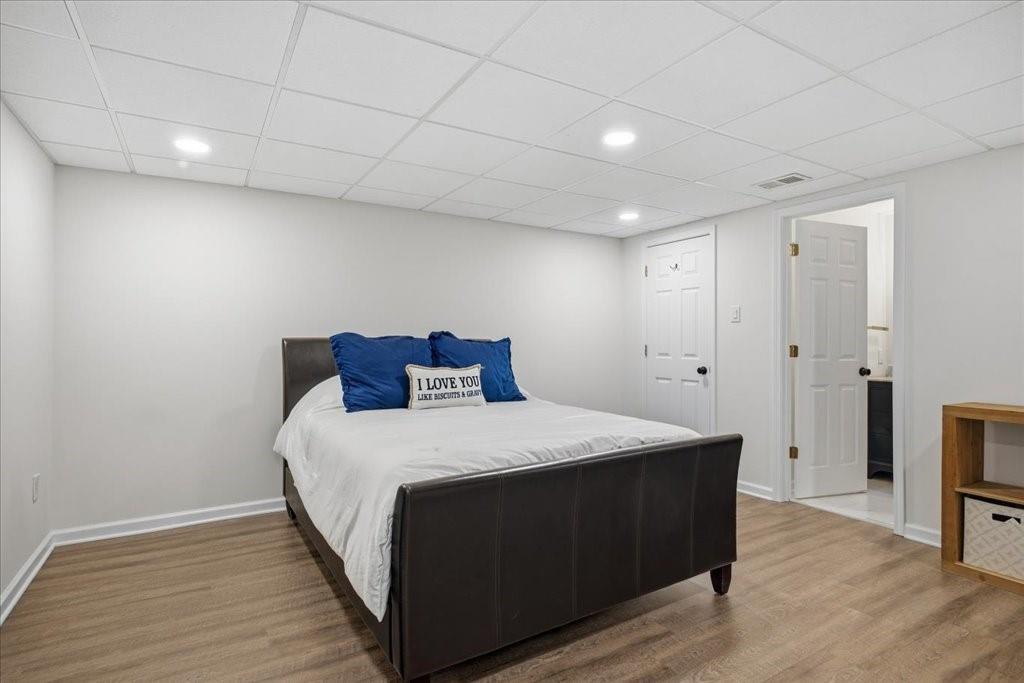 397 Thomas Road Dallas, GA 30132 - Photo 68 of 108 a bedroom with a bed and wooden floor