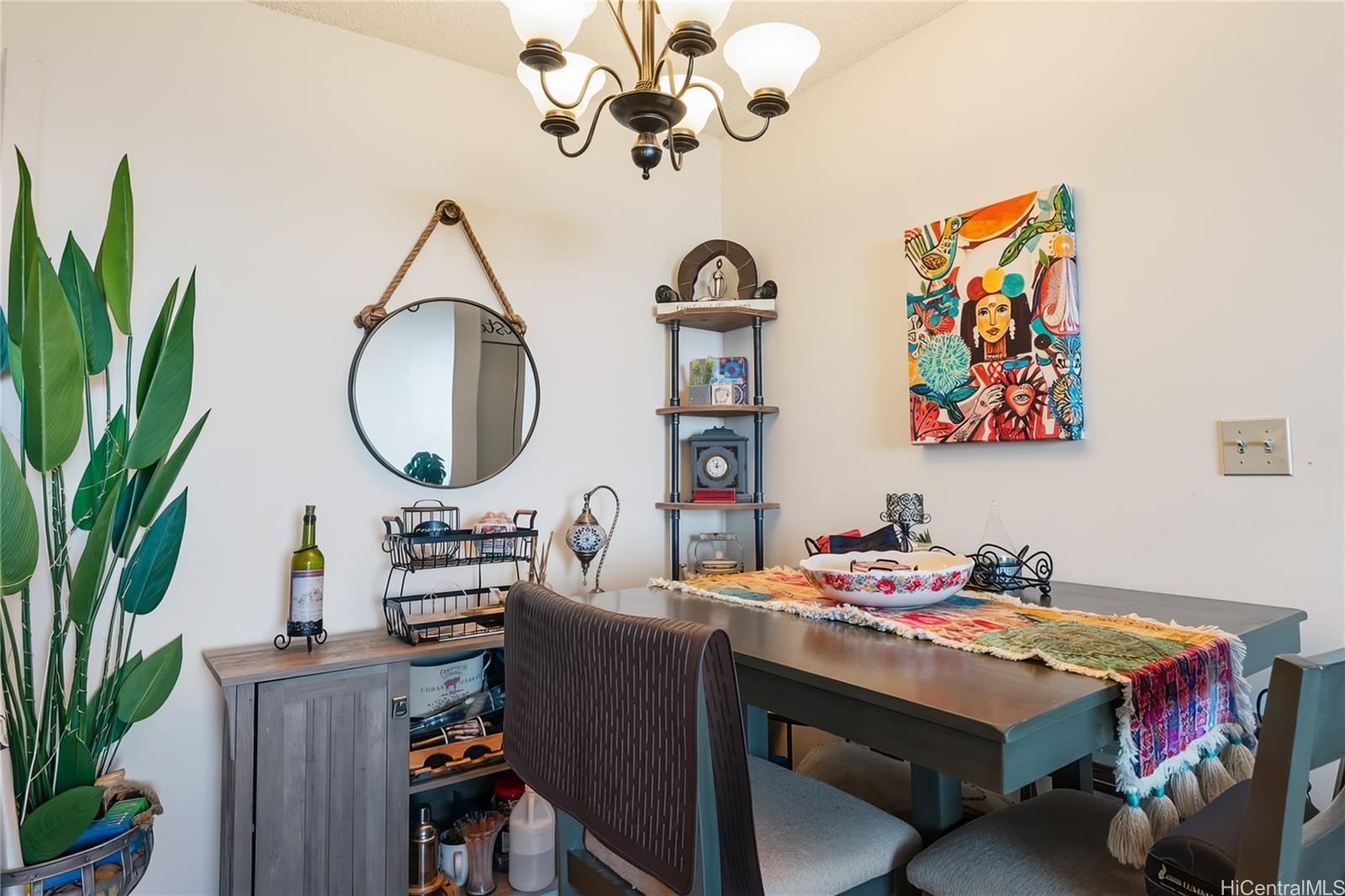 3045 Ala Napuaa Place, Unit 710 Honolulu, HI 96818 - Photo 11 of 25 a room with a table chairs and a chandelier