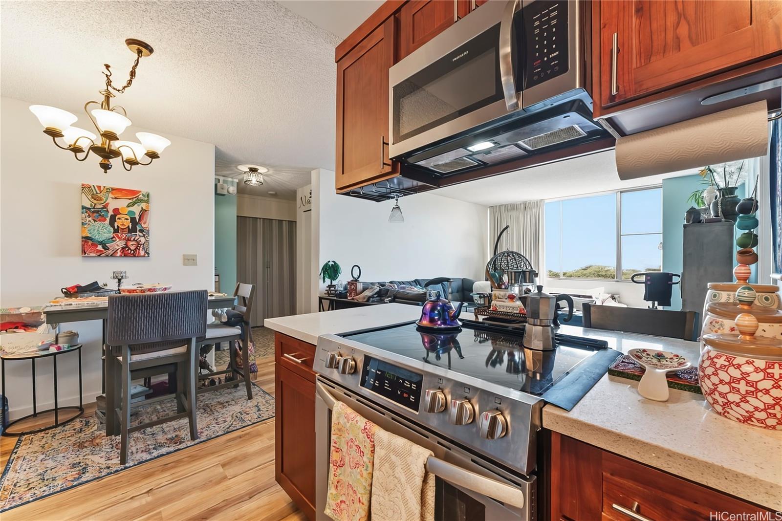 3045 Ala Napuaa Place, Unit 710 Honolulu, HI 96818 - Photo 12 of 25 a kitchen with stainless steel appliances granite countertop a stove a sink and a microwave