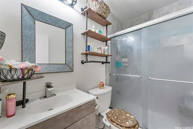 a bathroom with a sink a toilet and shower