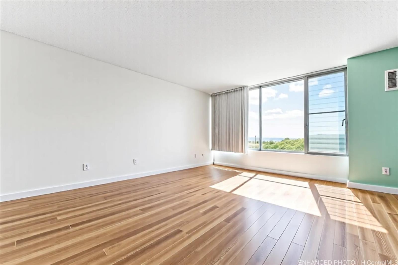 3045 Ala Napuaa Place, Unit 710 Honolulu, HI 96818 - Photo 3 of 25 wooden floor in an empty room with a window