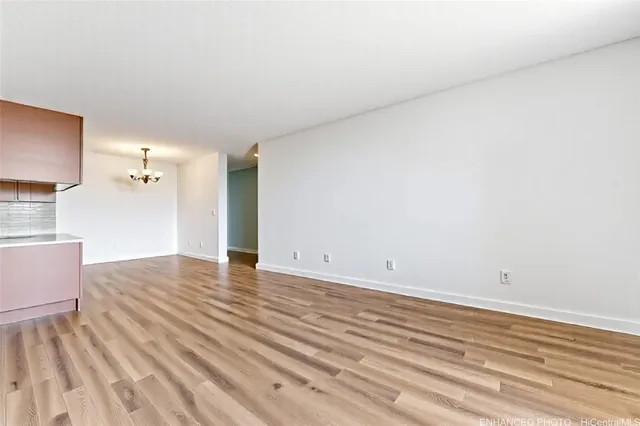 a view of a room with wooden floor and cabinet