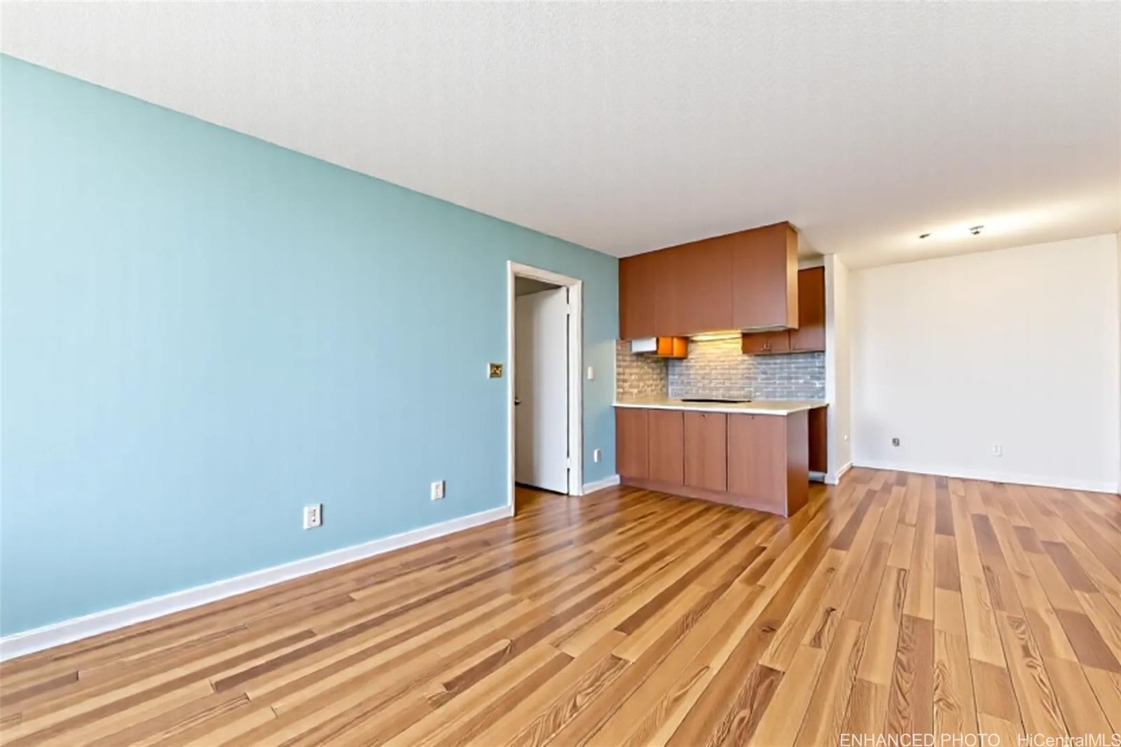 3045 Ala Napuaa Place, Unit 710 Honolulu, HI 96818 - Photo 6 of 25 a view of a kitchen with wooden floor and a sink
