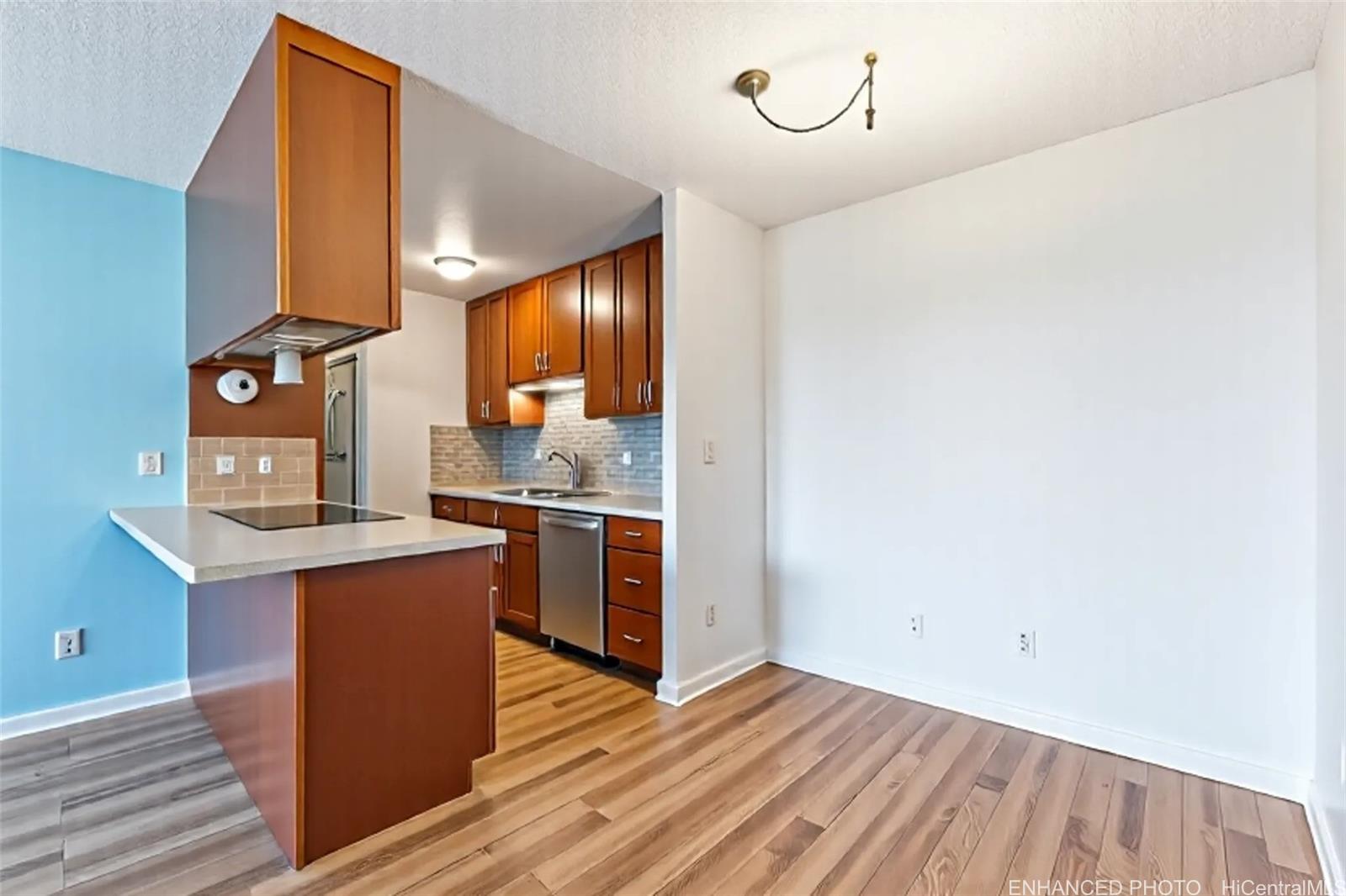 3045 Ala Napuaa Place, Unit 710 Honolulu, HI 96818 - Photo 7 of 25 a kitchen with stainless steel appliances granite countertop a sink stove and refrigerator