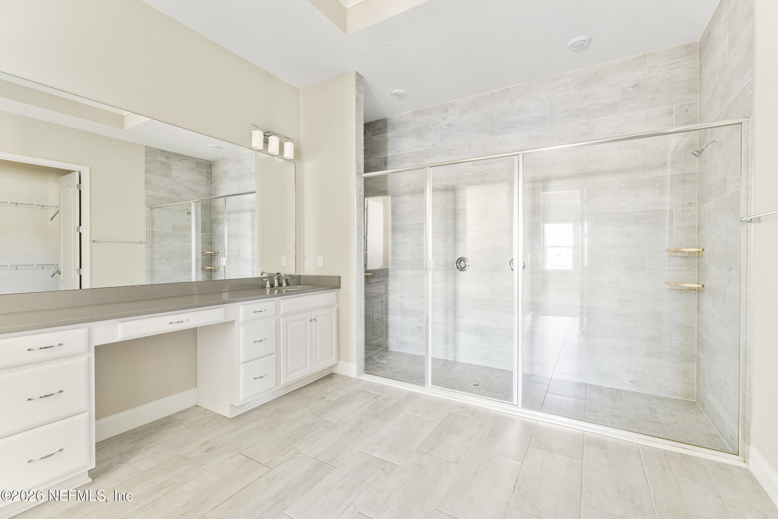 151 Calliel Way St. Johns, FL 32259 - Photo 15 of 35 a large bathroom with a shower sink and mirror