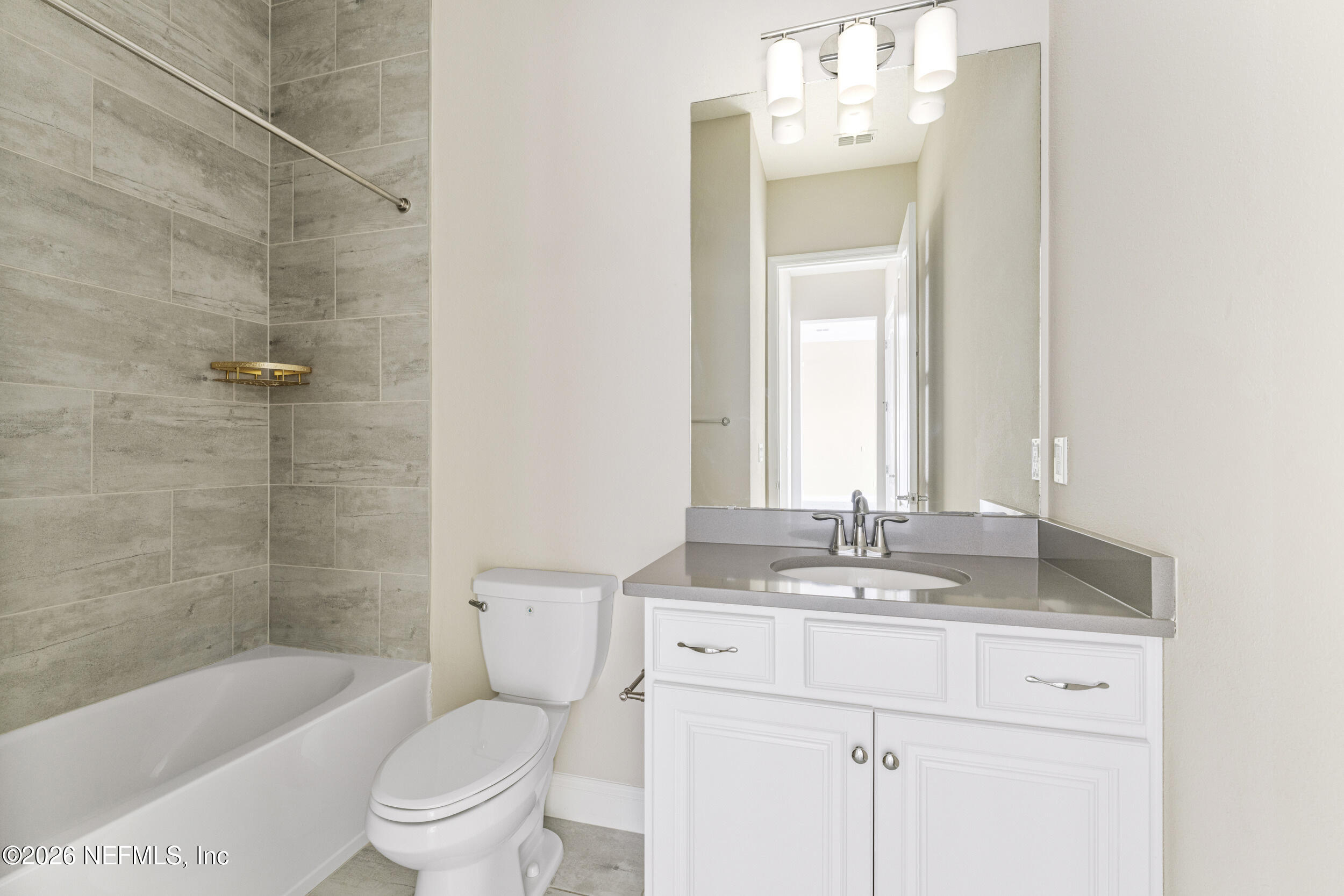 151 Calliel Way St. Johns, FL 32259 - Photo 23 of 35 a bathroom with a granite countertop sink toilet mirror and bathtub