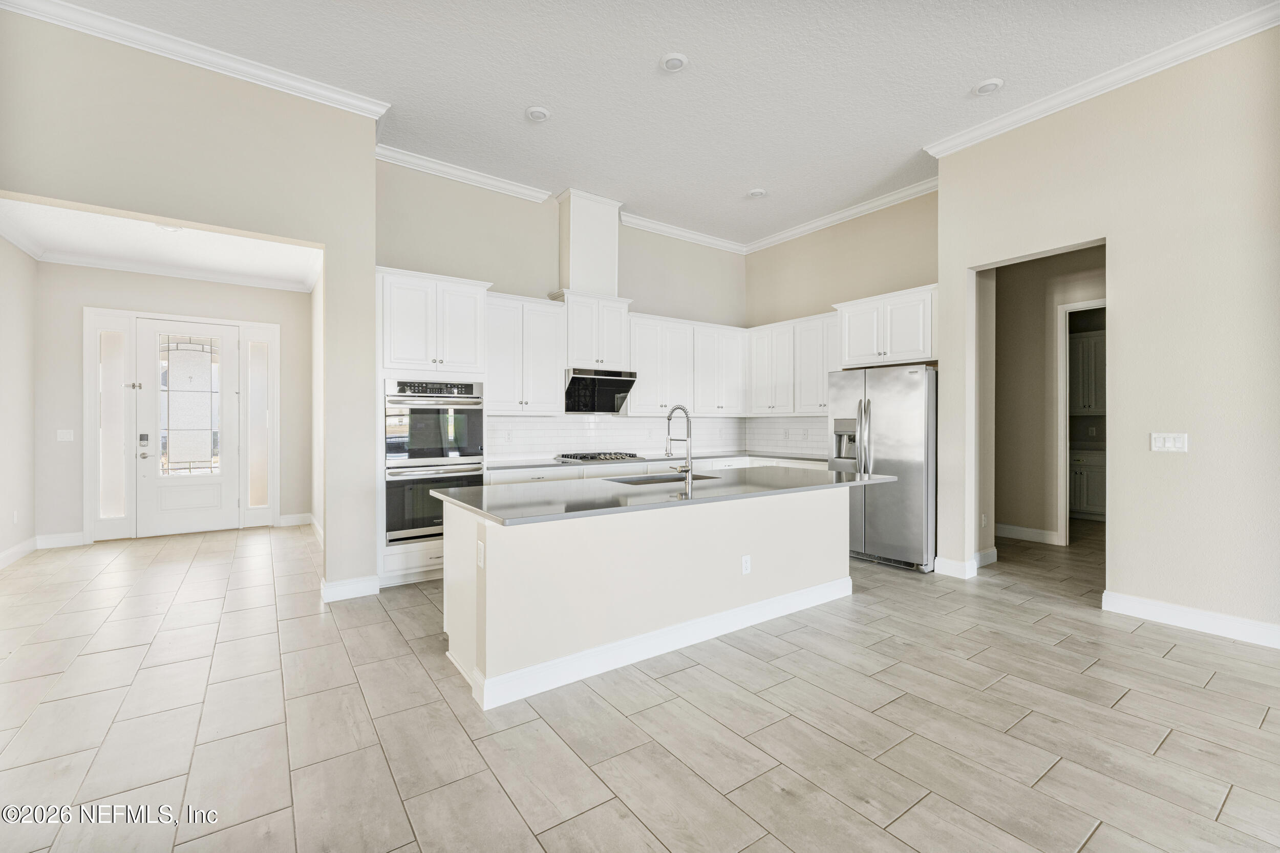 151 Calliel Way St. Johns, FL 32259 - Photo 5 of 35 a large white kitchen with cabinets and stainless steel appliances