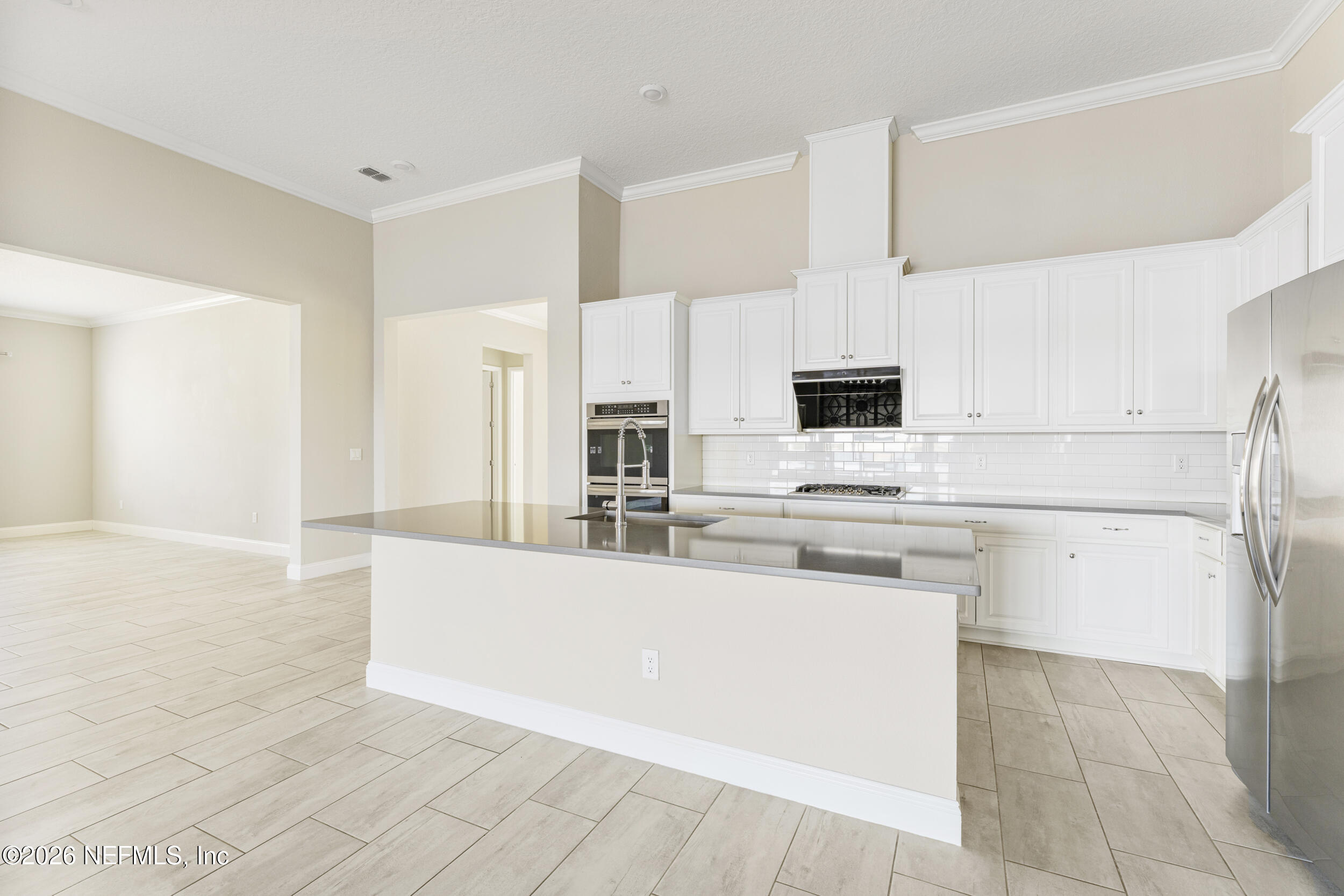 151 Calliel Way St. Johns, FL 32259 - Photo 6 of 35 a kitchen with stainless steel appliances a refrigerator sink and white cabinets