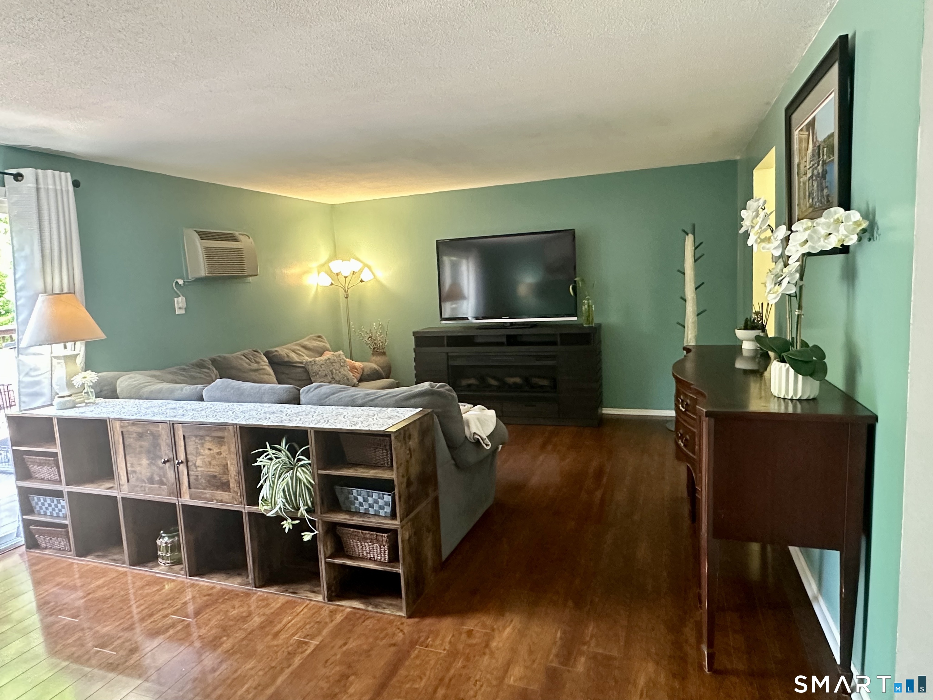 2 Lakeside Drive, Unit M Ledyard, CT 06339 - Photo 10 of 38 a room with furniture a flat screen tv and a dresser
