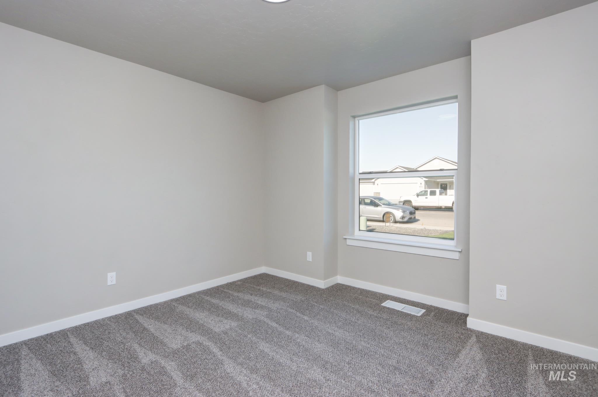 848 North 5th Street Nyssa, OR 97913 - Photo 30 of 49 Bright room featuring light gray wall paint, gray patterned carpet, white baseboards, and a single window with white trim