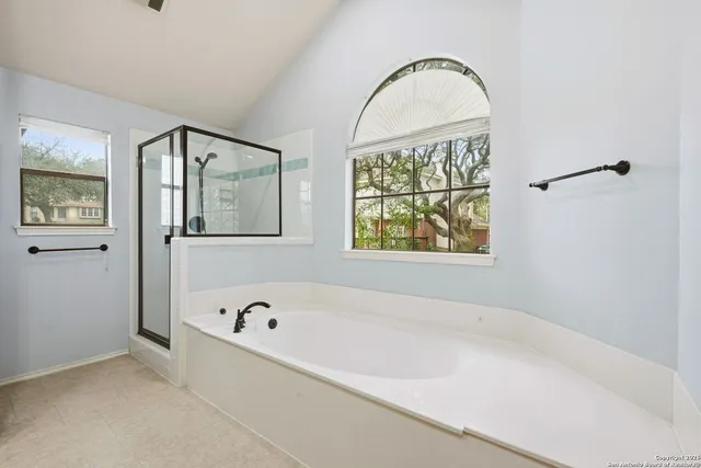 a bathroom with a bathtub and a window