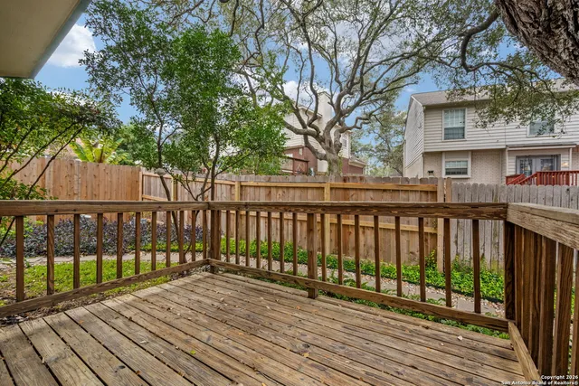 a view of wooden deck and a trees