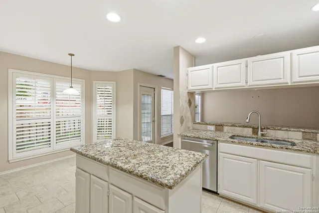 a kitchen with a sink stove and cabinets