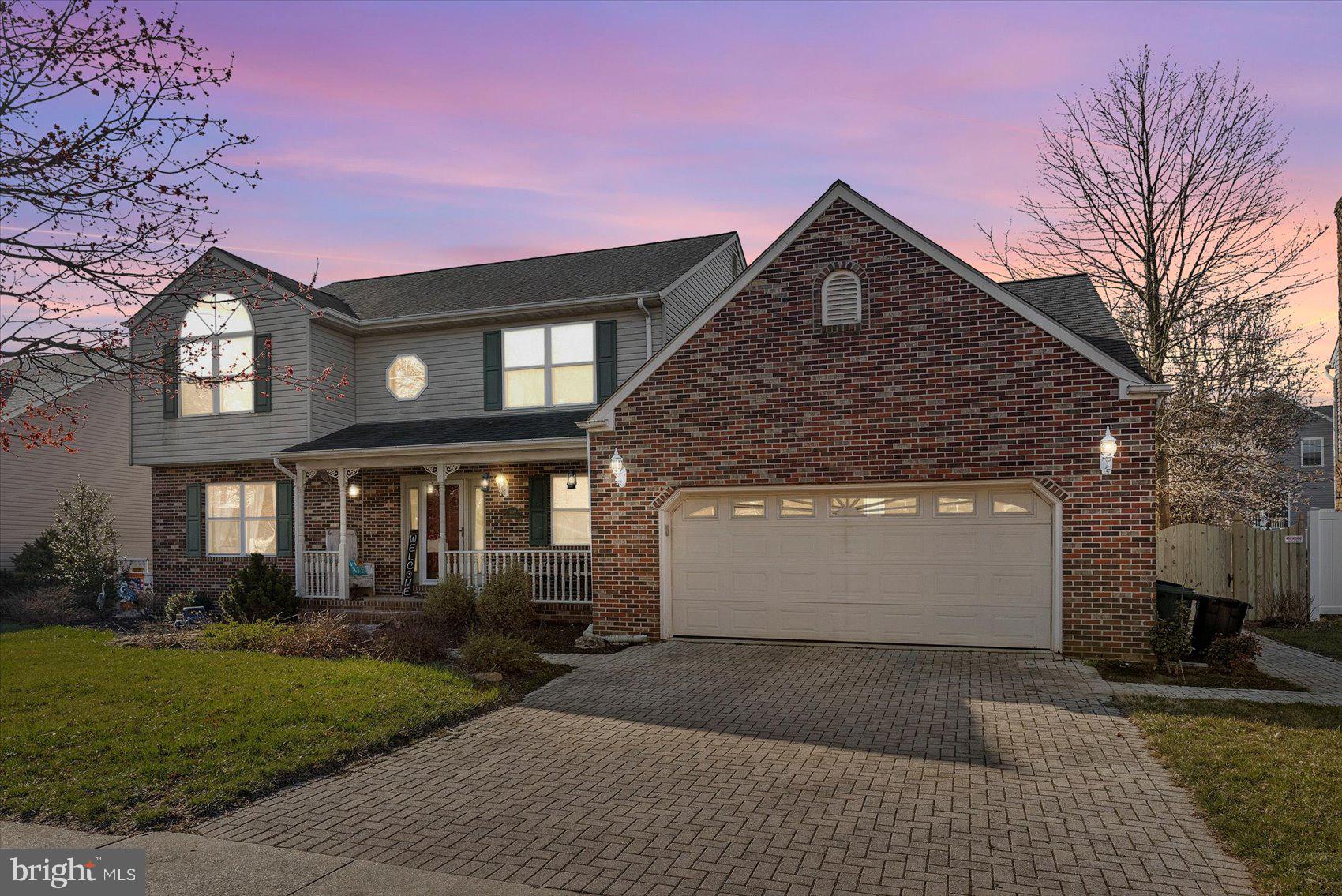 Front of home with paved driveway and 2 car garage