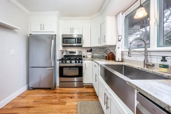 a kitchen with stainless steel appliances granite countertop a stove a sink and a refrigerator