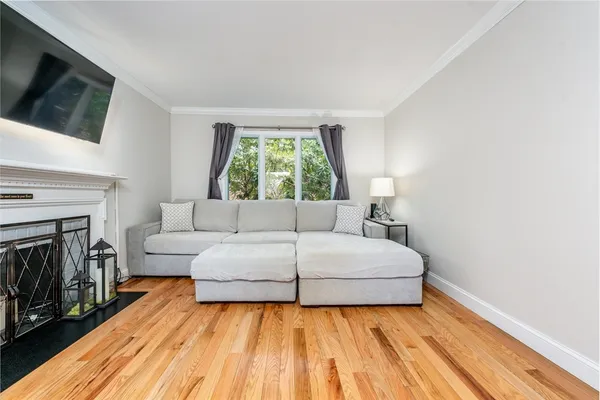 a living room with a bed and a flat screen tv