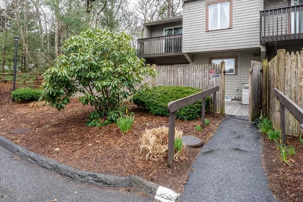 a view of a house with a yard and pathway