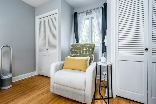 a bedroom with furniture and a book shelf