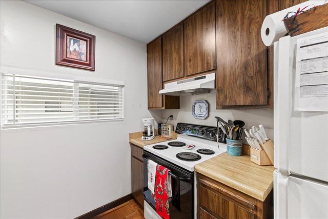 a kitchen with stainless steel appliances granite countertop a sink and a microwave