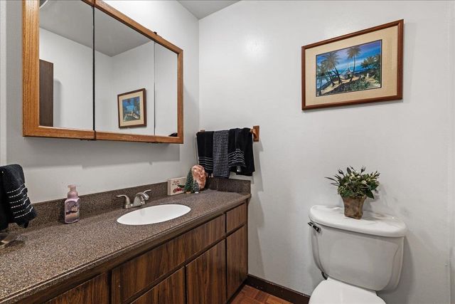 a bedroom with bed and a mirror