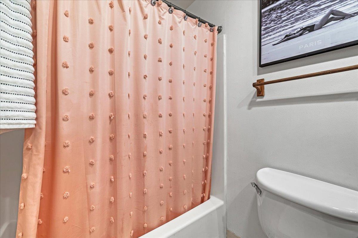 552 Walnut Street San Carlos, CA 94070 - Photo 20 of 27 a white toilet sitting next to a shower curtain