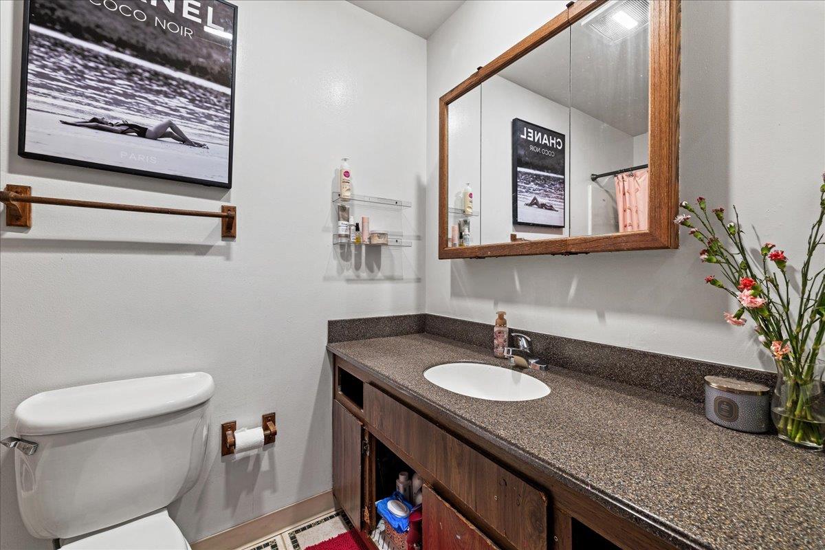 552 Walnut Street San Carlos, CA 94070 - Photo 23 of 27 a bathroom with a granite countertop sink and a mirror