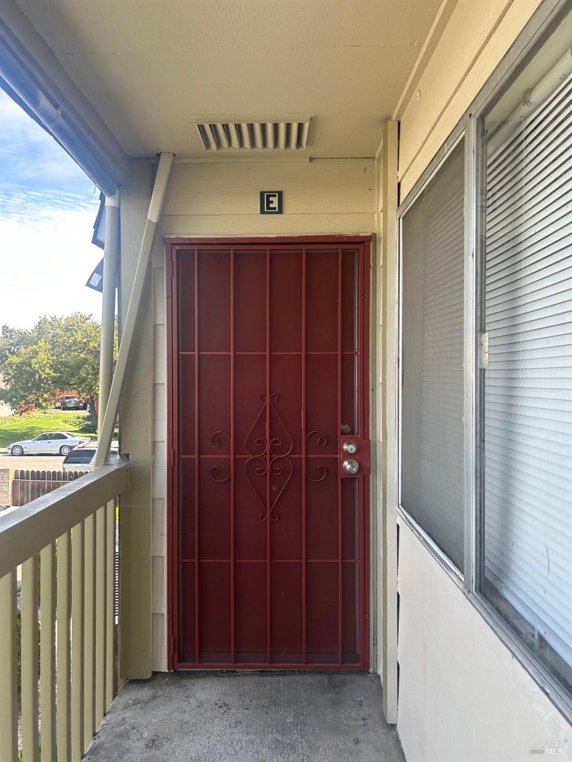 a view of a hallway with wooden door