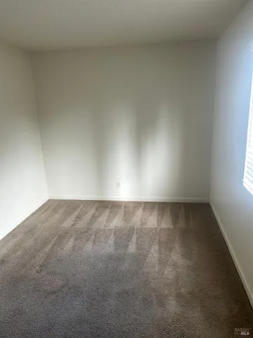a view of an empty room and a window
