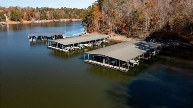 an aerial view of a house with pool lake view and mountain view