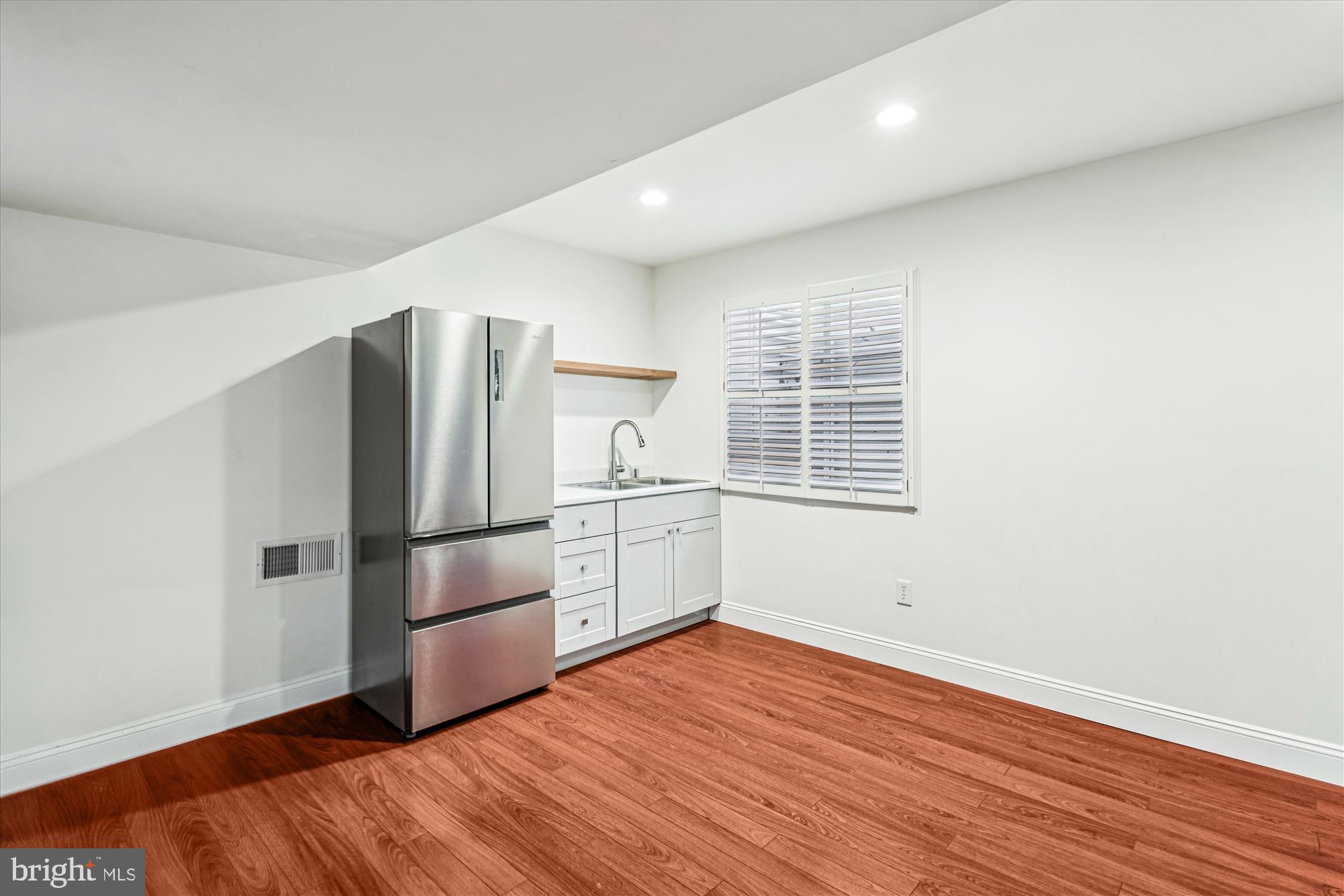 206 Heatherbloom Trail Gambrills, MD 21054 - Photo 37 of 46 a kitchen with a refrigerator and wooden floor