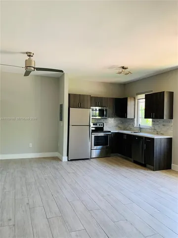 a large kitchen with a large counter top appliances and cabinets