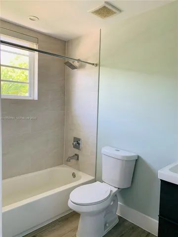 a bathroom with a toilet a sink and bathtub