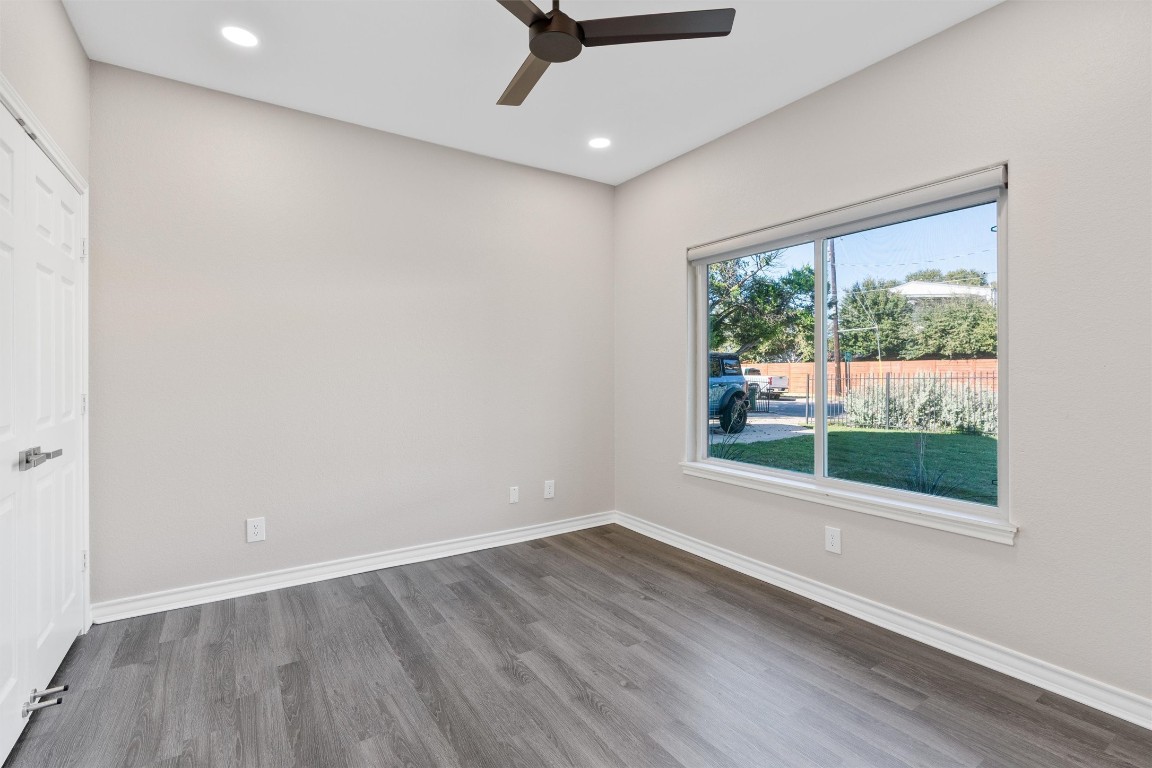 1209 Casey Street, Unit A Austin, TX 78745 - Photo 5 of 14 an empty room with wooden floor and windows