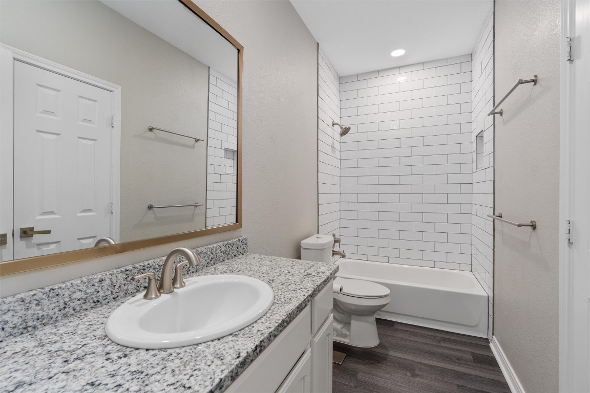 1209 Casey Street, Unit A Austin, TX 78745 - Photo 6 of 14 a bathroom with a granite countertop sink toilet and shower